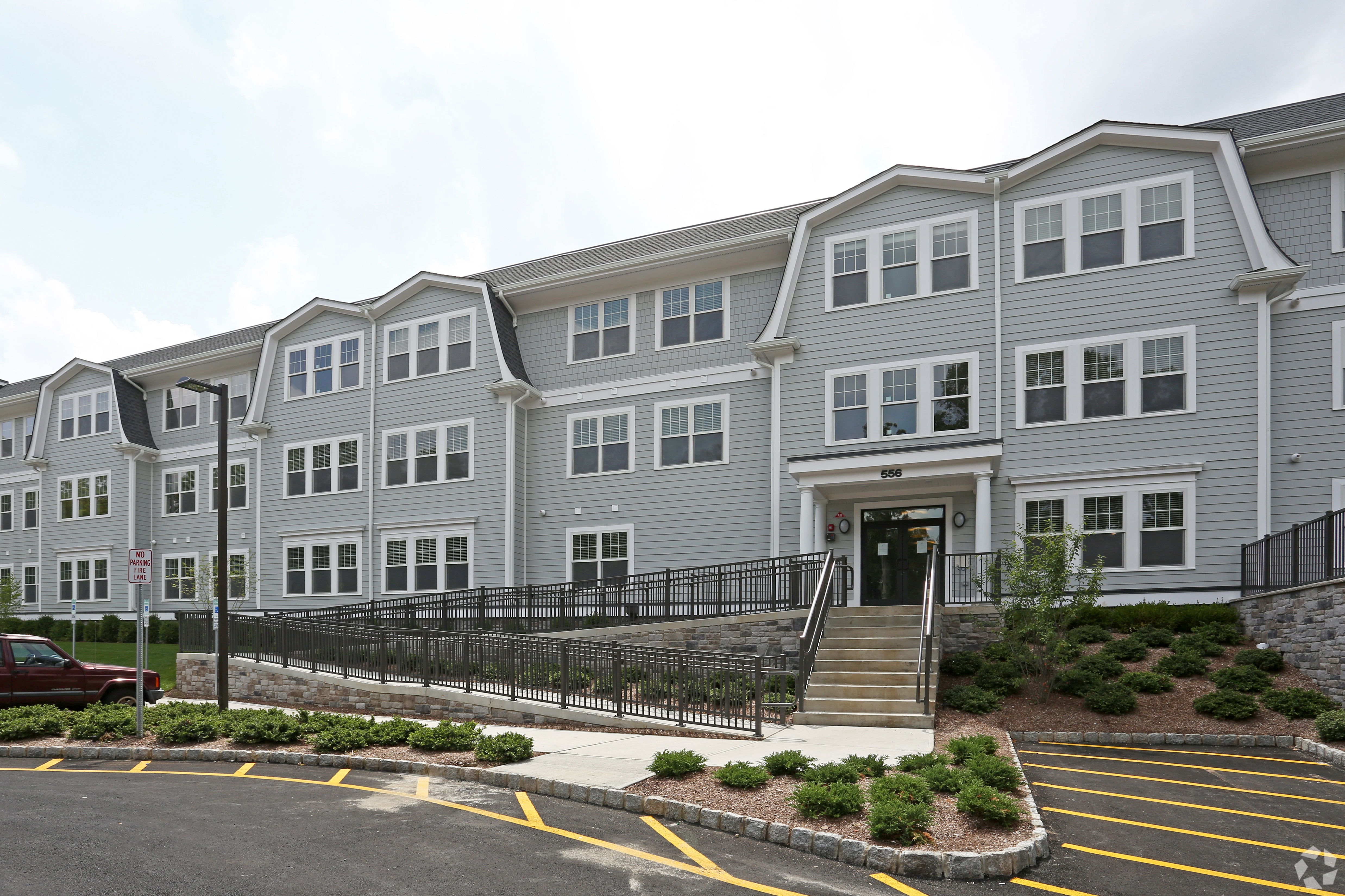 556 building exterior with accessible ramp and parking